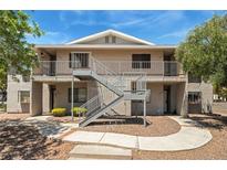 Apartment building featuring pedestrian access and outdoor walkways on a sunny day at 2898 Violet Ln # 0, Henderson, NV 89074