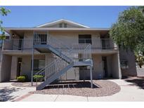 Apartment building with metal stairs and balcony and stucco exterior; unit numbers are clearly visible at 2898 Violet Ln # 0, Henderson, NV 89074
