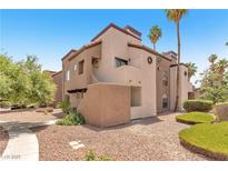 Attractive condo building with mature landscaping and a desert-style exterior at 2964 Juniper Hills Blvd # 104, Las Vegas, NV 89142