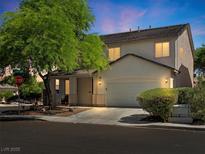 Charming two-story home features a well-manicured lawn, attached two-car garage and neutral exterior paint scheme at 4905 Apache Valley Ave, Las Vegas, NV 89131