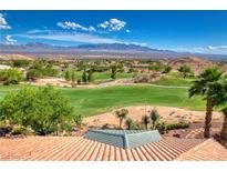 Expansive golf course view with lush greenery and mountain backdrop from the home's red tile roof at 522 Via Ventana Dr, Mesquite, NV 89027