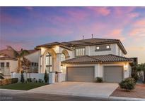 Beautiful two-story home with a tiled roof, arched entryway, and spacious three-car garage at 5225 Villa Dante Ave, Las Vegas, NV 89141