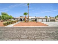 Charming single-story home featuring an attached three-car garage and desert landscaping at 544 N Fogg St, Las Vegas, NV 89110