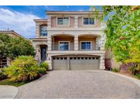Elegant two-story home featuring a three-car garage, beautiful balconies, and a well-manicured front yard at 6402 Parrot Ridge Ct, Las Vegas, NV 89139