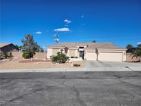 Charming single-story home with a three-car garage and desert landscaping on a sunny day at 7076 Oakleigh Dr, Las Vegas, NV 89110