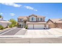 Charming two-story home with a three-car garage, tile roof, and well-maintained landscaping on a sunny day at 747 Canyon Crest Dr, Las Vegas, NV 89123