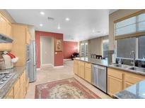 Spacious kitchen features granite countertops, stainless steel appliances, and wood cabinetry at 9900 Summer Ash Ct # 101, Las Vegas, NV 89134