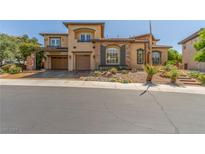 Charming two-story home with a three-car garage and well-maintained front yard at 9992 Peak Lookout St, Las Vegas, NV 89178