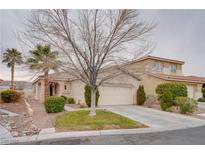 Charming single-story home featuring a stucco exterior, a well-manicured front yard, and an attached two-car garage at 10605 Moon Flower Arbor Pl, Las Vegas, NV 89144