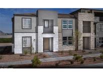Contemporary three-story home boasts stone and stucco, plus modern windows and a stylish entryway at 1168 Heliodor Ave # Lot 152, Henderson, NV 89011
