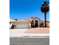 Charming single-story home featuring a well-maintained front yard and two-car garage at 1318 Pine Terrace Ct, North Las Vegas, NV 89031