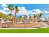 Beautiful resort-style villas with mature palm trees and a stunning tiered water feature at 2050 W Warm Springs Rd # 312, Henderson, NV 89014