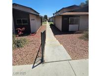 Apartment exterior showcasing building numbers and walkway under a sunny sky at 236 N Bruce St # C, Las Vegas, NV 89101