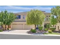 Inviting two-story home featuring a three-car garage, a well-manicured yard, and a tiled roof at 2753 Kildrummie St, Henderson, NV 89044