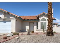 Charming single-story home features a tile roof, stucco exterior, and low-maintenance desert landscaping at 3236 Manzanita Ln, Laughlin, NV 89029
