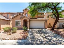 Charming two-story home featuring a stucco facade, arched entryway, tile roof, and a two-car garage at 4028 Spring Line St, North Las Vegas, NV 89032