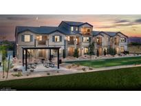 Beautiful multi-story townhomes with modern architecture, front lawns, and outdoor seating areas, perfect for community living at 624 Bellus Pl # Lot 170, Henderson, NV 89015