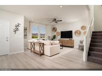 Bright living room featuring modern decor, a comfortable sofa, and scenic views through large windows at 624 Bellus Pl # Lot 170, Henderson, NV 89015