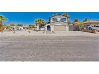 Charming two-story home with a well-manicured yard and an attached two-car garage at 652 Del Prado Dr, Boulder City, NV 89005