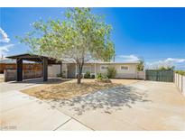 Charming single-story home featuring a covered carport, gravel yard, and mature landscaping under a bright blue sky at 67 Oklahoma Dr, Henderson, NV 89015