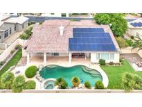 Aerial view of the backyard showcasing a private pool, spa, solar panels, and a covered patio at 7511 Bridlehorne Ave, Las Vegas, NV 89131