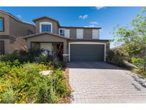 Charming two-story home with landscaped yard and brick driveway at 7732 Bandon Cliffs St, North Las Vegas, NV 89084