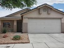 Charming single-story home featuring a two-car garage, desert landscaping, and a neutral color palette at 7801 Olympus Ave, Las Vegas, NV 89131