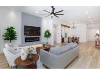 Bright living room with sleek fireplace, large TV, modern ceiling fan, and stylish, contemporary decor at 81 Alerion St, Las Vegas, NV 89138