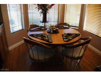 Sunlit breakfast nook features a wood table, four chairs, and a bay window at 9355 W Viking Rd, Las Vegas, NV 89147