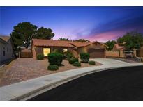 Charming single-story home featuring a tile roof, attached garage, and desert landscaping for easy maintenance at 1929 Stonington Pl, Las Vegas, NV 89108