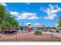 Charming single-story home featuring a well-maintained yard, neutral paint, gray roof, and an inviting orange front door at 4419 Lorna Pl, Las Vegas, NV 89107