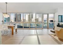Bright and airy living room featuring floor-to-ceiling windows with city views, modern decor and hardwood flooring at 4471 Dean Martin Dr # 1109, Las Vegas, NV 89103