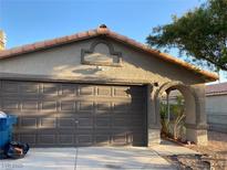Attached home featuring a spacious two car garage with a beautiful archway at 5353 Hollow Brook Ave, Las Vegas, NV 89142