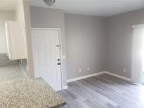 Bright living room featuring new gray flooring and neutral wall color at 5655 E Sahara Ave # 2068, Las Vegas, NV 89142