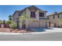 Two-story home with a stucco exterior, three-car garage, tile roof, and a small balcony at 5712 French Lace Ct, North Las Vegas, NV 89081