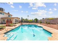 A pristine in-ground pool is surrounded by lush greenery and offers a refreshing oasis for relaxation and recreation at 6612 Elton Ave, Las Vegas, NV 89107