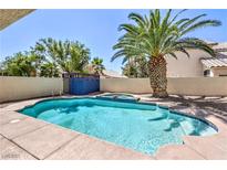 Sparkling pool with a mature palm tree provides a relaxing outdoor oasis at 7633 Raven Hills Dr, Las Vegas, NV 89149