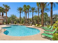 Community pool with palm trees and lounge seating at 8000 Badura Ave # 2028, Las Vegas, NV 89113