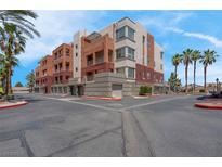 Attractive multi-story condo building with balconies and desert landscaping at 87 E Agate Ave # 403, Las Vegas, NV 89123