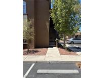 Apartment building exterior with staircase, landscaping, and parking spot visible in the foreground at 9000 Las Vegas Blvd # 2189, Las Vegas, NV 89123