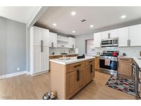 Bright kitchen with white and wood cabinets, stainless steel appliances, and a center island at 915 Melrose Dr, Las Vegas, NV 89101