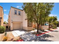 Charming two-story home featuring a garage and a well-maintained front yard with gravel and a sidewalk at 10164 Village Breeze Pl, Las Vegas, NV 89183