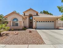 Single-story home featuring desert landscaping, a tile roof, and an attached two-car garage at 110 Eagleview Ct, Henderson, NV 89074