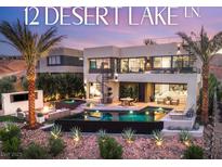 Stunning home featuring a luxurious pool, spa, fire pit, spiral staircase, and desert landscaping under a colorful sky at 12 Desert Lake Ln, Henderson, NV 89011