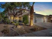 Charming two-story home featuring a three-car garage, desert landscaping, and mature trees creating curb appeal at 1306 Big Tree Ave, North Las Vegas, NV 89031