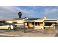 Charming single-story home featuring solar panels, covered porch, carport, and well-maintained front yard at 2217 Santa Ynez Dr, Las Vegas, NV 89104