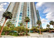 A high-rise condominium building with lush landscaping, palm trees, and a resort-style pool, creating an inviting outdoor space at 222 Karen Ave # 2804, Las Vegas, NV 89109