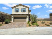 Two-story home showcasing a desert landscape, brown garage door and blue shutters at 2343 Teatro Ave, Henderson, NV 89044