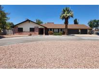 Charming single-story home featuring a circular driveway, red brick accents and mature landscaping at 2645 Lindell Rd, Las Vegas, NV 89146