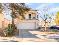 Two-story home featuring a balcony, two car garage, xeriscaped front yard, and a red tile roof at 2789 Trotwood Ln, Las Vegas, NV 89108
